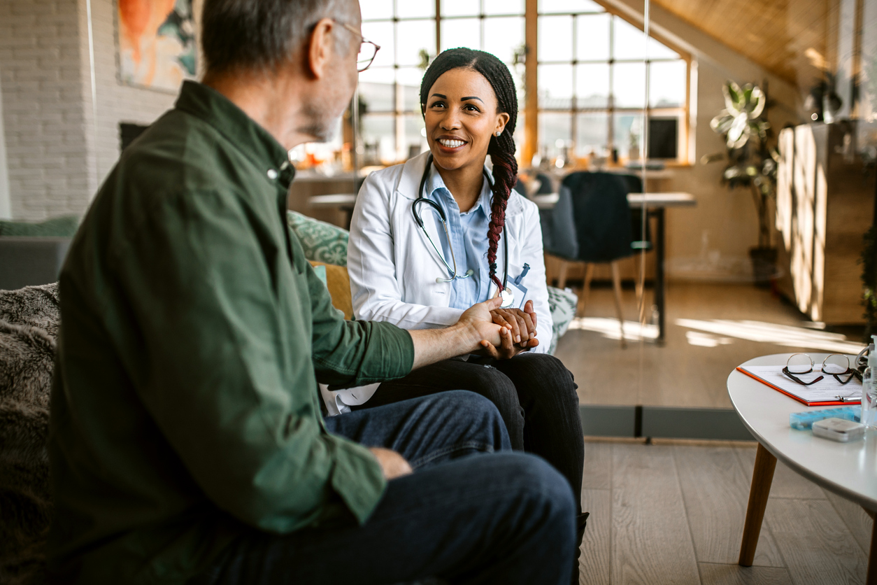 doctor providing medical house call to senior patient