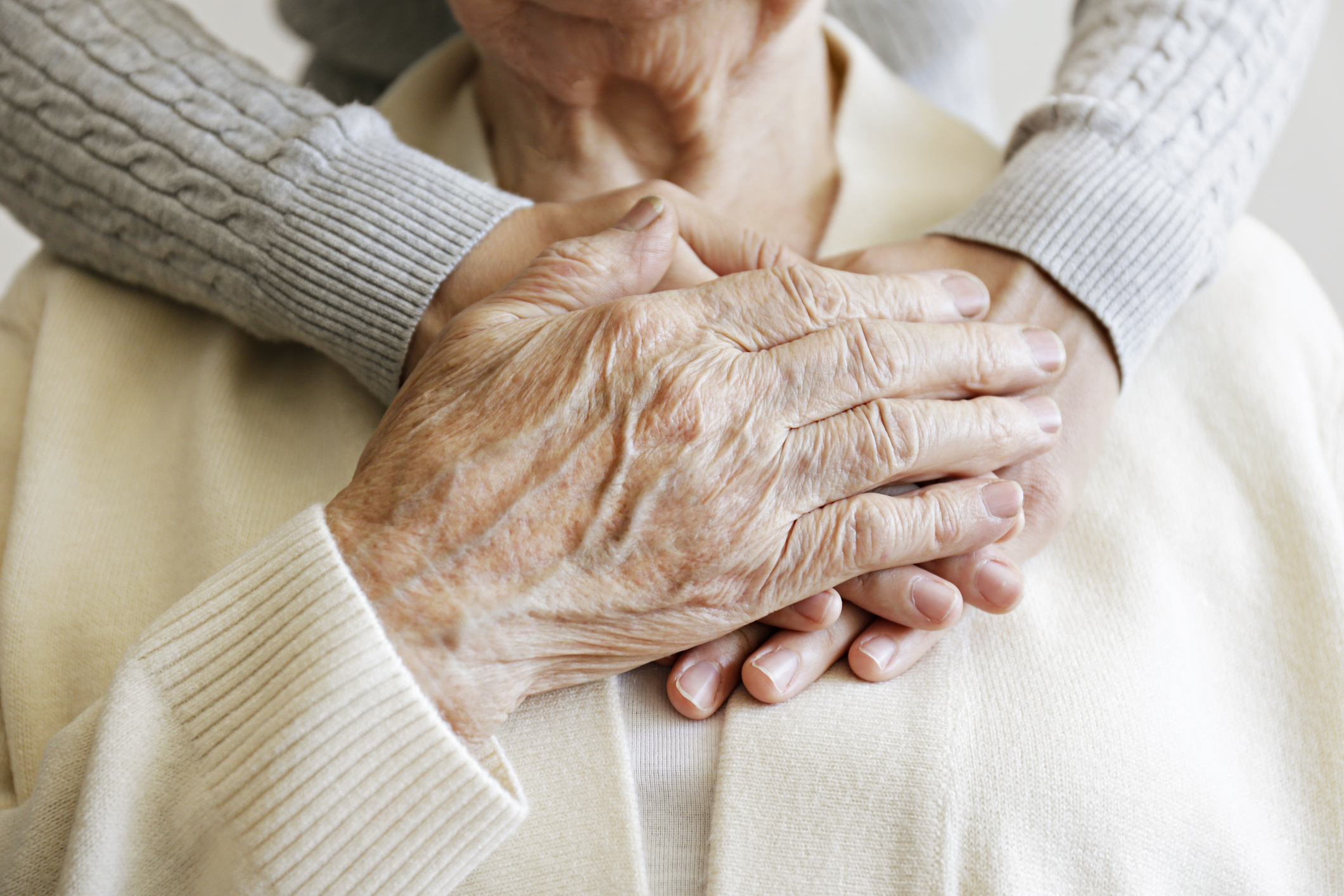 closeup hands around an elderly man representing what is the difference between comfort care and hospice care