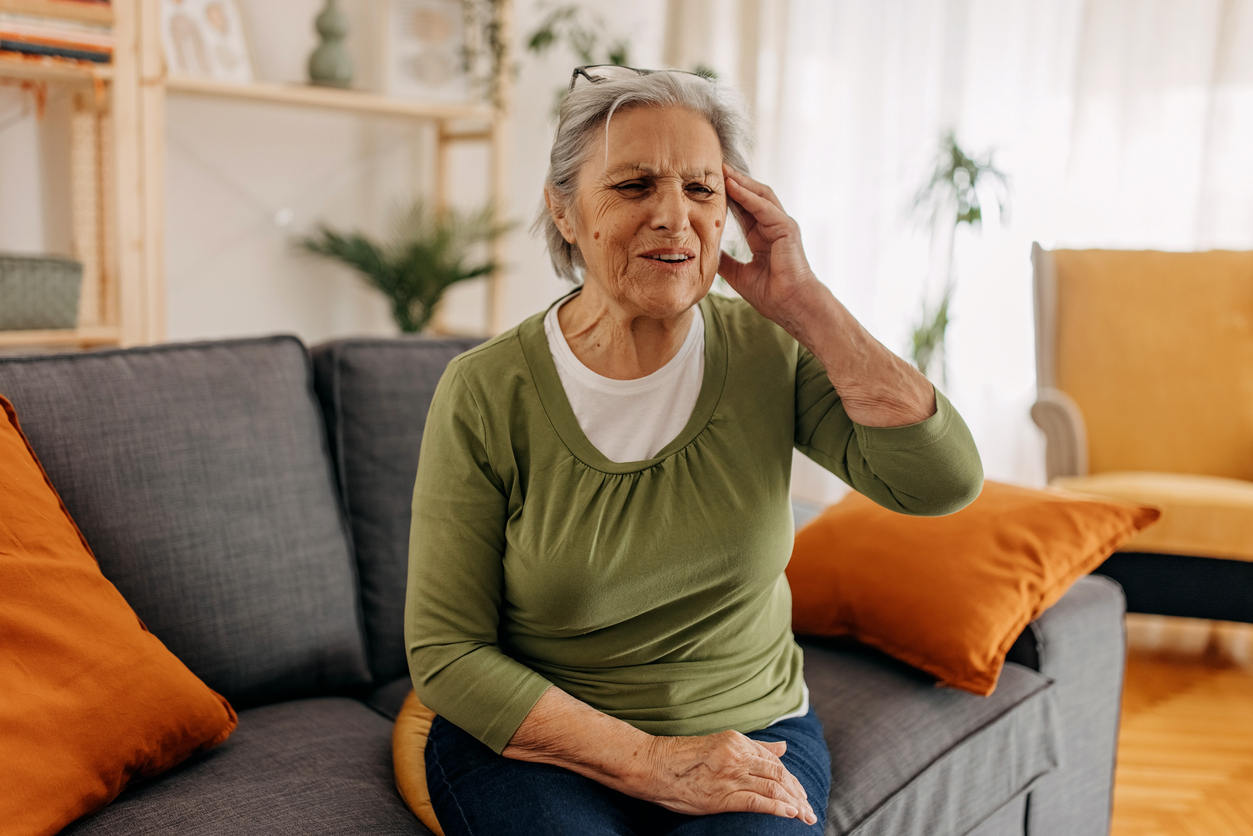 An older woman who has a headache in need of a primary care doctor who helps chronic conditions